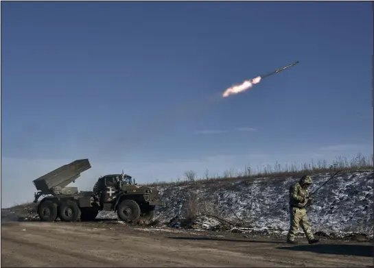  ?? LIBKOS — THE ASSOCIATED PRESS ?? A Ukrainian army rocket launcher fires at Russian positions Wednesday near Soledar, in the Donetsk region of Ukraine.