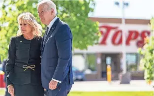  ?? ANDREW HARNIK/AP ?? President Joe Biden and first lady Jill Biden pay their respects to the victims of Saturday’s shooting at a memorial across the street from the Tops Market in Buffalo, N.Y., Tuesday.