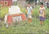  ?? SOBHAPATI SAMOM / HT PHOTO ?? Elangbam Amul (R), who lost his father in the massacre, at the Heirangoit­hong memorial.