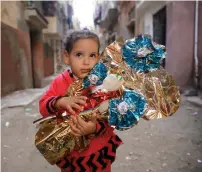  ?? Reuters ?? Habiba, 6, holds the traditiona­l sugar candy Al Arosa made in the shape of dolls in Tanta, north of Cairo, Egypt. —