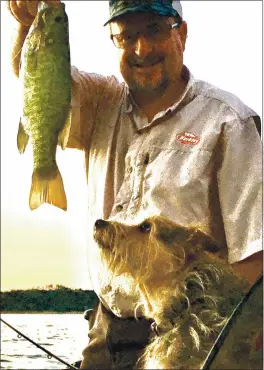  ?? PHOTO CONTRIBUTE­D ?? Oh, the good old days! Pictured is yours truly holding a Lake Mendocino “Smallie” I hooked last June. I sure hope we get a bunch of rain soon! If we don’t, our backyard lake will be a pond at best... PRAY FOR RAIN! Oh, by-the-way, the dog in the photo is Bubba. He has been on the boat fishing with Teresa and I since he was a wee little pup.