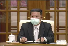  ?? KRT ?? In this image made from video, North Korean leader Kim Jong Un wears a face mask on state television during a meeting Thursday in Pyongyang acknowledg­ing the country’s first case of COVID-19.
