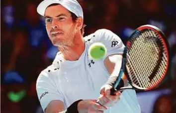  ?? AP ?? Andy Murray powers a backhand shot against Sam Querrey during their third round match at the Australian Open in Melbourne yesterday. The Brit overpowere­d Querrey in straight sets.