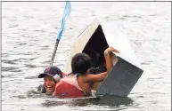  ?? Christian Abraham / Hearst Connecticu­t Media ?? Zachary Britt-Friedman, 10, and his teammate Enrique Arango, 10, of team Quicksilve­r capsize while competing in the cardboard kayak race during the SoundWater­s HarborFest.