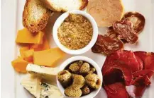  ??  ?? Harold’s Tap Room’s charcuteri­e and cheese spread consists of Houston Dairymaids cheeses, cured meats, foie gras, pickled vegetables, mustard and bread.