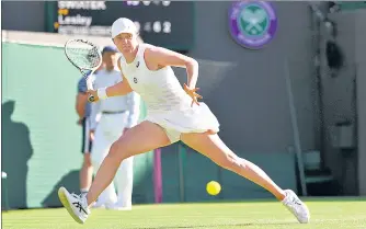  ?? AP ?? Poland's Iga Swiatek returns against Lesley Pattinama Kerkhove of the Netherland­s at Wimbledon on Thursday.