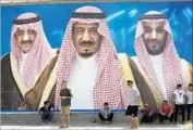  ?? Amr Nabil Associated Press ?? SAUDI King Salman is f lanked by Mohammed bin Nayef and Mohammed bin Salman on a billboard.