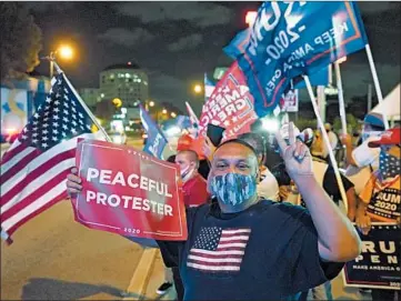  ?? WILFREDO LEE/AP ?? Supporters of President Donald Trump chant and wave flags during Election Night in Miami’s Little Havana.