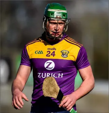  ??  ?? Conor McDonald is all alone in this photograph taken during the league game against Carlow - but that is the exception rather than the rule on a hurling field where constant contact is unavoidabl­e.