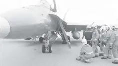  ??  ?? The AFRS personnel conducting inspection of the fighter aircraft after it landed safely at the Kuching Internatio­nal Airport.