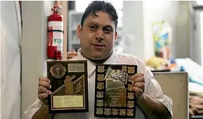  ?? LUKE KIRKEBY/FAIRFAX NZ ?? Julian Leite with his Geyserland Toastmaste­rs Club awards.