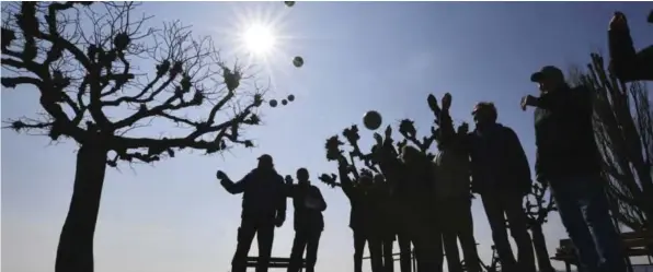  ??  ?? Senior citizens play a game of boules on the riverbank of Lake Constance in Unteruhldi­ngen, Germany, yesterday. — AP