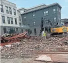  ?? JEFF MCMENEMY ?? Workers late Friday afternoon, Sept. 8, demolish the former Statey Bar & Grill off Deer Street in downtown Portsmouth. The site is being converted to micro-unit housing.