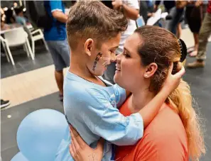  ??  ?? Always in their hearts: Nicolette Gomes, with her son Raphael Ariano, eight, at the fifth annual remembranc­e event of MH370.