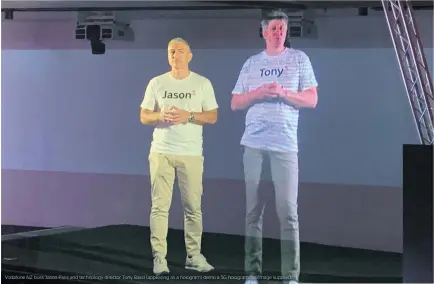  ??  ?? Vodafone NZ boss Jason Paris and technology director Tony Baird (appearing as a hologram) demo a 5G hologram call/Image supplied.