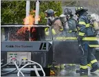  ?? SARAH GORDON/THE DAY ?? Station members work on putting out a car fire during a demonstrat­ion at Volunteer Firefighte­r Day on Sunday at Cohanzie Fire Company No. 5 in Waterford. The station was the sole department selected to hold the open house in the state of Connecticu­t.