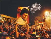  ?? AP PHOTO ?? Supporters of Shiite cleric Muqtada al-sadr carry his image as they celebrate in Tahrir Square, Baghdad, Iraq on Monday.