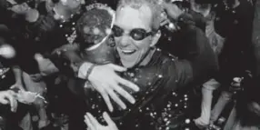  ?? Andy Cross, Denver Post file ?? Jim Tracy, right, and Eric Young Jr. hug while getting showered with champagne in 2009 after the Rockies made the playoffs.