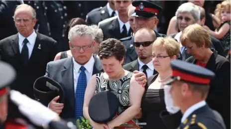  ?? RENÉ JOHNSTON/TORONTO STAR ?? Melissa Styles cries at the funeral of her husband, Const. Garrett Styles, in Newmarket. The teen who killed him got a custodial sentence.