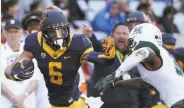  ?? Rob Griffith / Associated Press ?? Quarterbac­k Davis Webb, a transfer from Texas Tech, made a good first impression by completing 38 of 54 passes for 441 yards and four touchdowns with no intercepti­ons in his Cal debut. He also ran for a score. Cal’s Chad Hansen tries to fend off a...