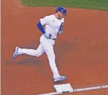  ?? NUCCIO DINUZZO/GETTY IMAGES ?? Ian Happ rounds the bases after his solo homer in the fourth inning of Game 1, which tied the score 1-1.