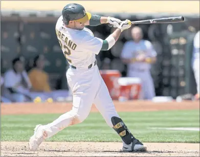  ?? JEFF CHIU — THE ASSOCIATED PRESS ?? The A’s Ramon Laureano hits a two-run double during the sixth inning of Tuesday’s victory over the Los Angeles Angels.