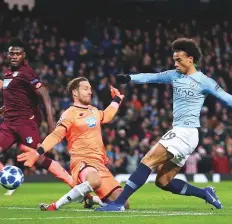  ?? AP ?? Manchester City midfielder Leroy Sane scores his second goal past Hoffenheim goalkeeper Oliver Baumann during the Champions League Group F match at the Etihad Stadium.