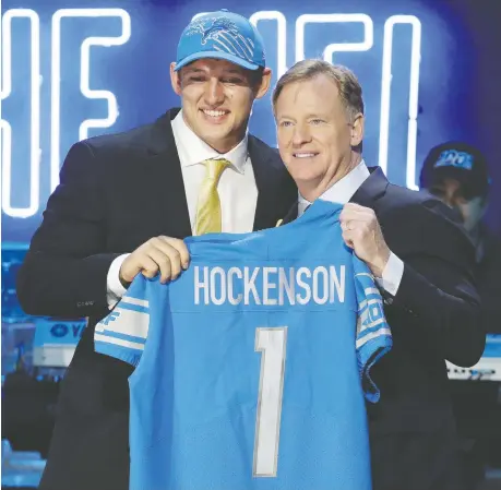  ?? STEVE HELBER/THE ASSOCIATED PRESS ?? Iowa tight end T.J. Hockenson shows off his new team sweater with NFL commission­er Roger Goodell after the Detroit Lions selected Hockenson in the first round of the NFL Draft Thursday in Nashville.