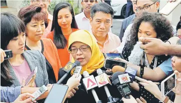  ??  ?? Halimah speaks to the media at the Elections Department after she was given the certificat­e of eligibilit­y to contest the election by the Presidenti­al Elections Committee. — Reuters photo