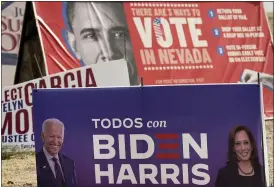  ?? JAE C. HONG — THE ASSOCIATED PRESS ?? A campaign sign supporting Democratic presidenti­al candidate former Vice President Joe Biden and running mate Kamala Harris stands in front of a vote sign showing former President Barack Obama near the Clark County Election Department in North Las
Vegas, Nev., on Friday.