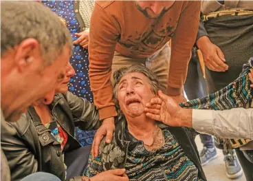  ?? (AFP) ?? A relative mourn during the funeral of a couple and their daughter killed in a rocket attack, in the city of Ganja, Azerbaijan, on Saturday