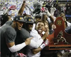  ??  ?? Alabama team members celebrate after the Southeaste­rn Conference championsh­ip NCAA college football game against Florida on Saturday in Atlanta. AP PHOTO