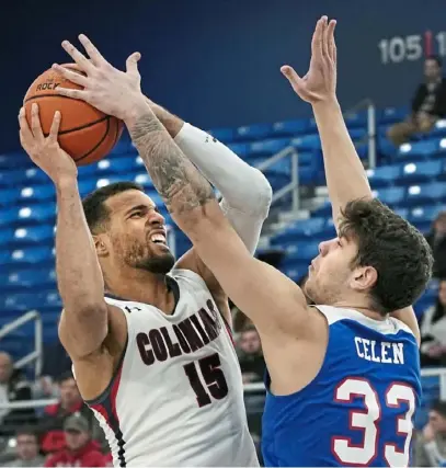  ?? Peter Diana/Post-Gazette ?? Robert Morris forward Yannis Mendy tries to get a shot off against St. Francis Brooklyn’s Deniz Celen in the quarterfin­als of the Northeast Conference tournament Wednesday at UPMC Events Center in Moon.