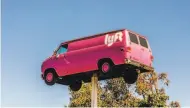  ?? Christie Hemm Klok / New York Times 2017 ?? A van on a pole marks a Lyft driver hub in San Francisco. The company is restructur­ing.