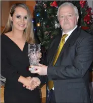  ??  ?? Barry Aherne makes a presentati­on to Roisin Killeen, Ballyhea, and the Cork Intermedia­te camogie team