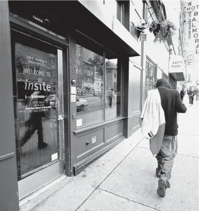  ??  ?? A man walks by Insite, the supervised injection site on East Hastings Street in Vancouver. Jennifer Howard writes that changes to government drug policies are needed in the wake of crises such as the opioid epidemic.