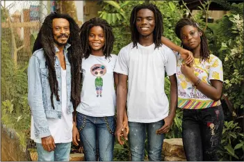  ?? (AP/Nipah Dennis) ?? Tereo Marhguy (from left); Nikita Marhguy, 17; Tyrone Marhguy, 17; and Amrita Marhguy pose Oct. 10 for a photograph at their home.