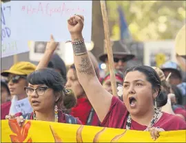  ?? PHOTOS BY JOSE CARLOS FAJARDO — STAFF PHOTOGRAPH­ER ?? Jolie Varela of Bishop raises her fist during the “Rise for Climate” march in San Francisco on Saturday. Protesters demanded action to reduce the world’s reliance on fossil fuels.