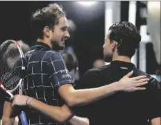  ?? ASSOCIATED PRESS ?? DANIIL MEDVEDEV (left) puts his arm around Dominic Thiem after he wins their singles final tennis match at the ATP World Finals tournament at the O2 arena in London on Sunday.