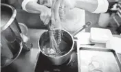  ?? NICOLE CRAINE/THE NEW YORK TIMES 2019 ?? New federal guidelines call for a reduction in sodium levels. Above, a chef adds salt to caramel at an inn in Southold, New York.