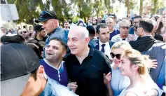  ?? (GPO) ?? PRIME MINISTER Benjamin Netanyahu and his wife, Sara, join the public in the Wohl Rose Garden, opposite the Knesset, on Independen­ce Day.