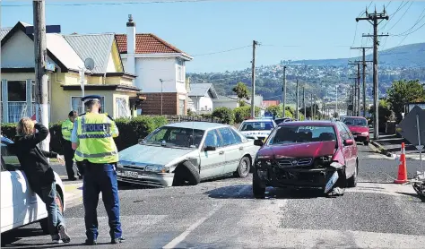  ?? PHOTO: CHRISTINE O’CONNOR ?? Mangled . . . A twocar crash at the intersecti­on of Tedder and Market Sts yesterday was the third serious accident at the South Dunedin intersecti­on since it was changed to accommodat­e the South Dunedin cycle network.