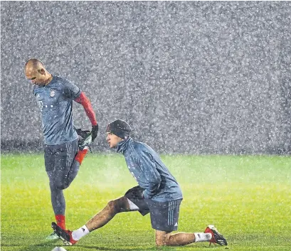  ?? CHRISTOF STACHE AFP/GETTY IMAGES ?? Bayern Munich’s Arjen Robben, left, and Thomas Mueller train Monday on the eve of the Group E match against Benfica Lisbon.