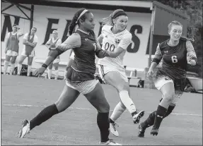  ?? Photo courtesy of JBU Sports Informatio­n ?? John Brown University senior Hannah Poor splits a pair of defenders during Thursday’s match against Wayland Baptist (Texas).