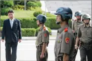  ?? SOUTH KOREAN UNIFICATIO­N MINISTRY VIA GETTY IMAGES ?? North Korea soldiers stand guard at the border village of Panmunjom during high level talks between North Korea and South Korea on Monday. North Korea wants a formal end declared to the Korean War, but U.S. officials are cool to the idea.