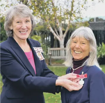  ?? ?? HM Lord Lieutenant of West Sussex, Mrs Susan Pyper, present s Celia Powis with the British Empire Medal for services to fitness and especially Popmobilit­y. Pic S Robards SR2111242