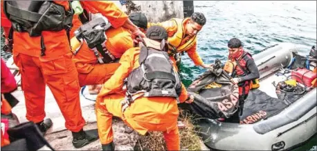  ?? IVAN DAMANIK/AFP ?? Rescue team members prepare to search for missing passengers at the Lake Toba ferry port in the province of North Sumatra on Wednesday after a boat capsized on Monday.