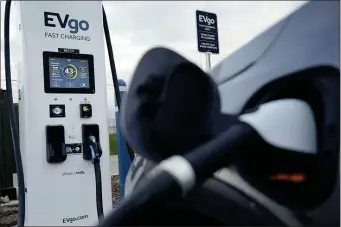  ?? PAUL SANCYA — THE ASSOCIATED PRESS ?? An electric vehicle charges at an EVgo fast charging station in Detroit.