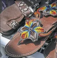  ??  ?? The Espoire D'Afrique booth has sandals, clothing and beaded bangles with an African influence.