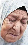  ??  ?? Fahamiya Shamasneh, 75, cries as Israeli policemen evict her from her family home, in which they lived for over half a century, in the Arab neighborho­od of Sheikh Jarrah in east Jerusalem, on Tuesday. (AFP)
